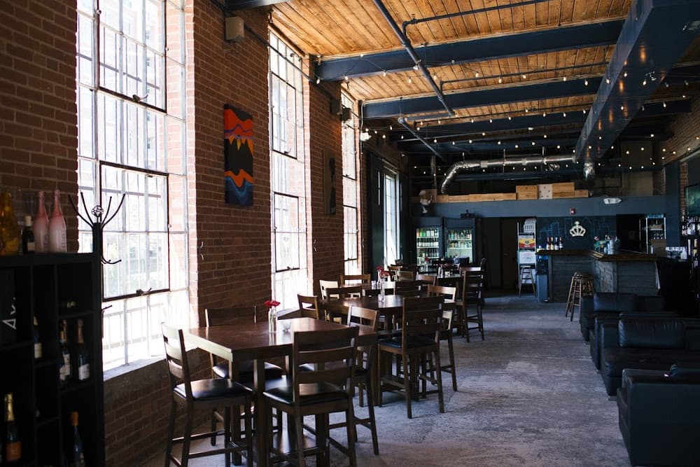 Vin Master wine bar interior — warm brick walls, string lights, Charlotte NC